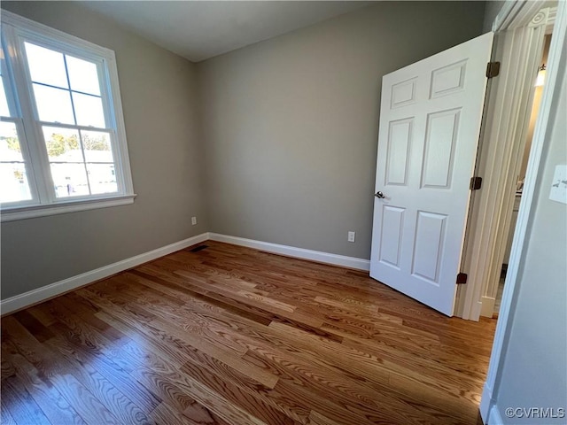 empty room featuring wood-type flooring