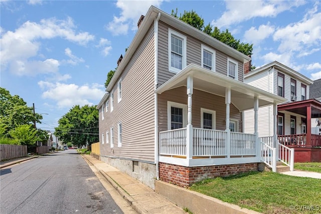 view of front of house with covered porch and a front lawn