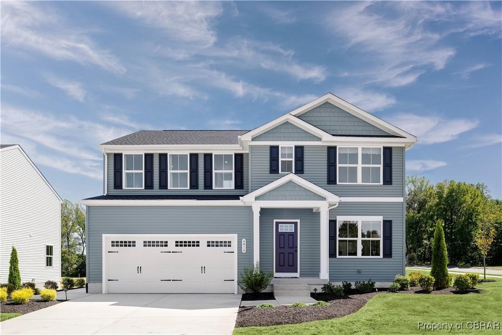 view of front of home with a garage and a front lawn