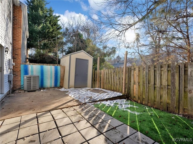 view of patio featuring cooling unit and a shed