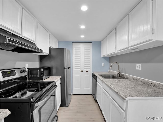 kitchen featuring stainless steel appliances, sink, white cabinets, light hardwood / wood-style flooring, and ventilation hood