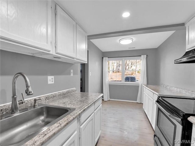 kitchen with stainless steel electric range, light wood-type flooring, white cabinetry, and sink