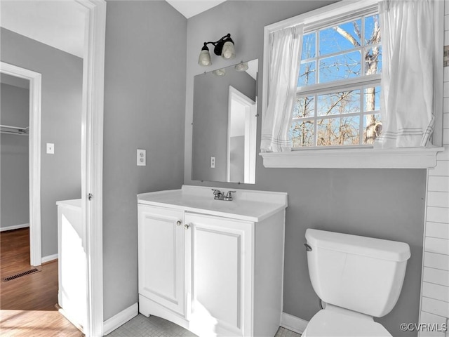 bathroom featuring toilet and vanity