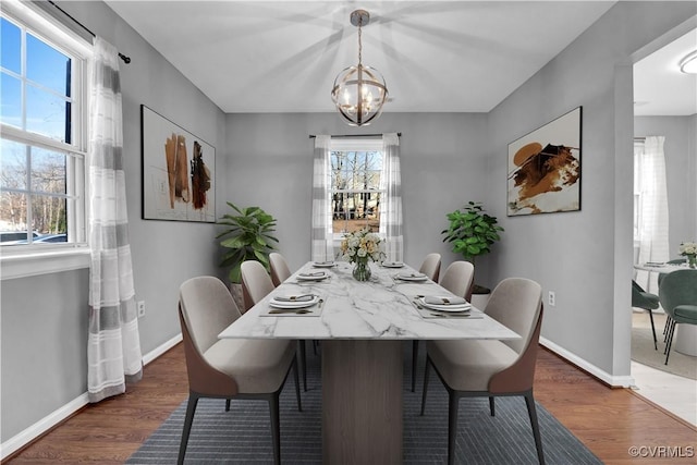 dining room featuring a notable chandelier and dark hardwood / wood-style floors