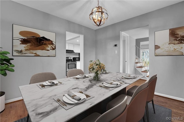 dining space featuring a chandelier and dark wood-type flooring