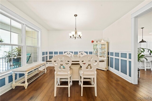 dining space featuring an inviting chandelier and dark wood-type flooring