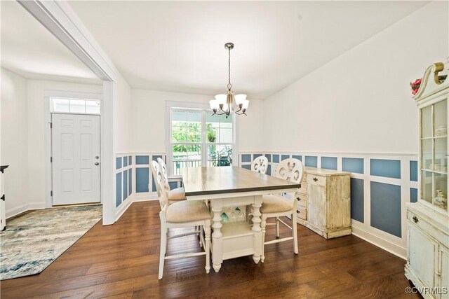 dining space featuring a notable chandelier and dark hardwood / wood-style floors