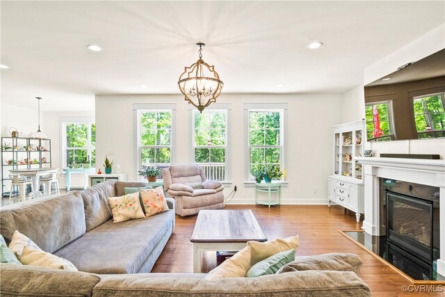 living room with wood-type flooring and an inviting chandelier