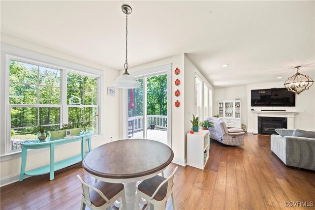 dining area featuring hardwood / wood-style floors and a notable chandelier