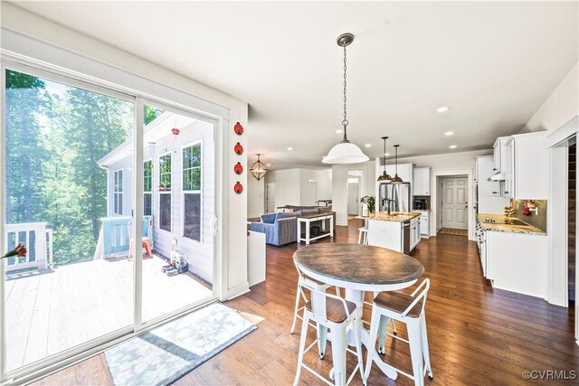 dining area with dark hardwood / wood-style flooring