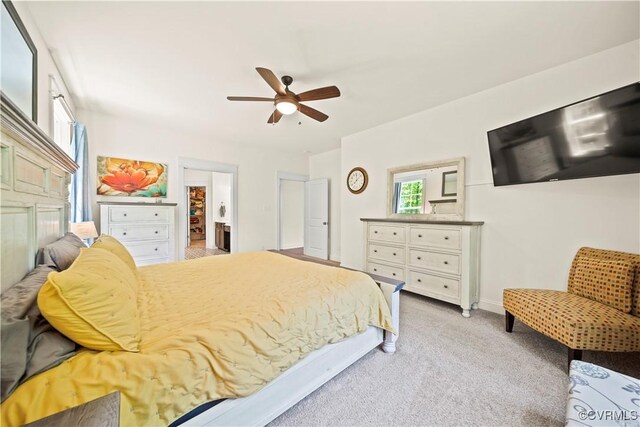 bedroom featuring light carpet and ceiling fan