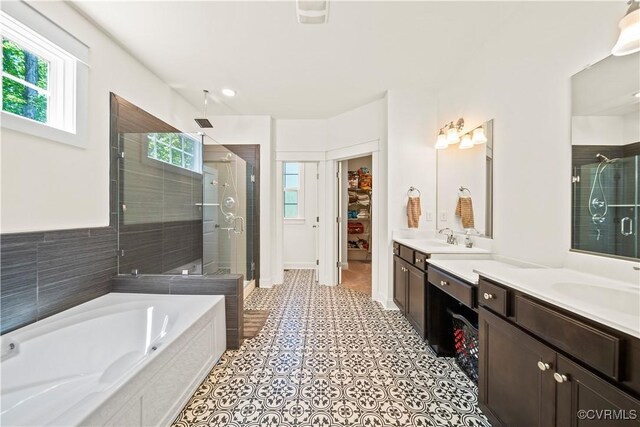 bathroom with vanity and separate shower and tub