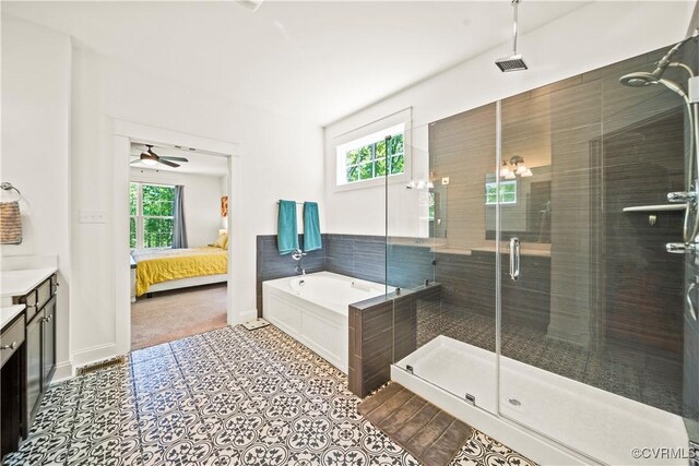 bathroom with independent shower and bath, vanity, tile patterned flooring, and a wealth of natural light