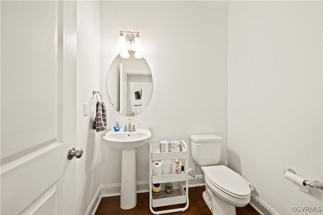 bathroom with sink, wood-type flooring, and toilet