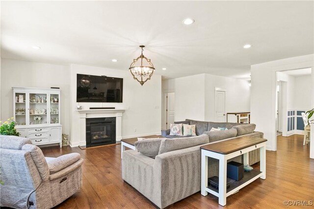 living room with hardwood / wood-style floors and a notable chandelier