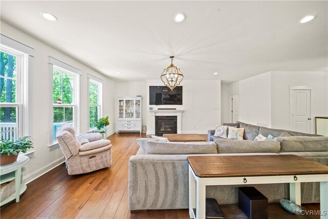 living room with hardwood / wood-style flooring and a chandelier