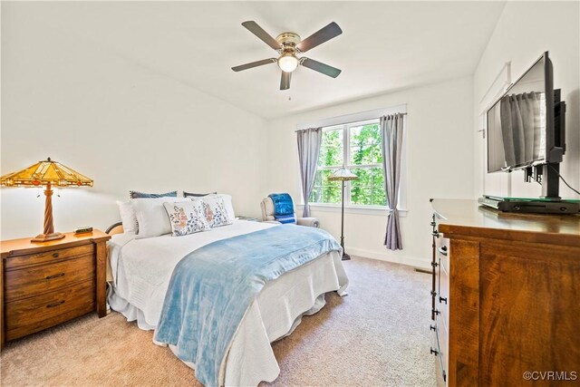 bedroom featuring ceiling fan and light colored carpet