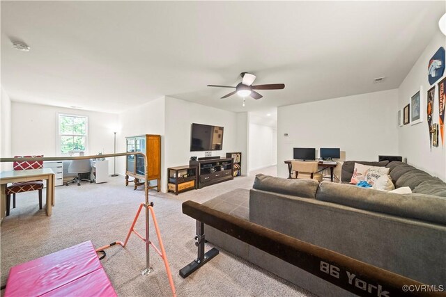 carpeted living room with ceiling fan