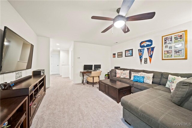 carpeted living room with ceiling fan