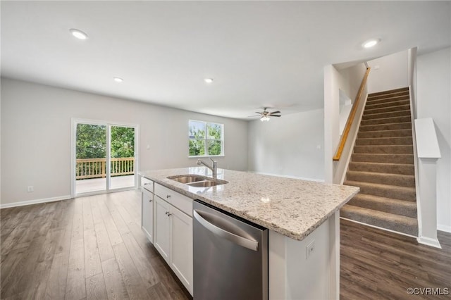 kitchen with dishwasher, a center island with sink, sink, ceiling fan, and white cabinetry