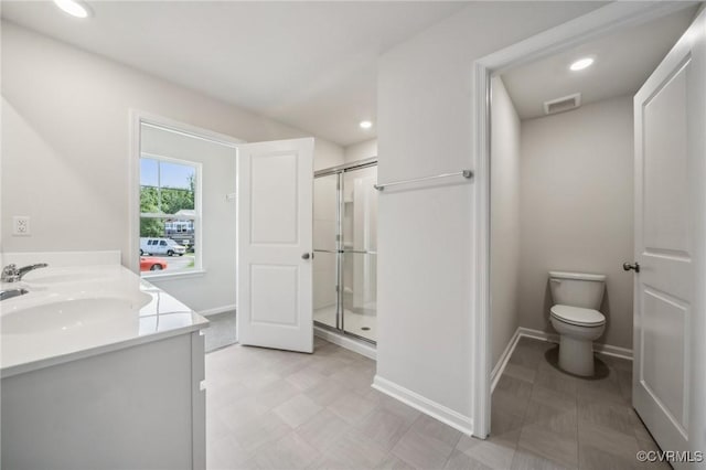 bathroom with a shower with door, vanity, and toilet