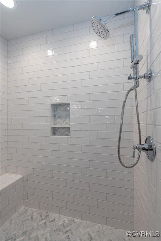 bathroom featuring tiled shower