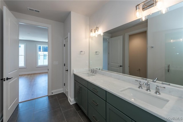 bathroom with tile patterned floors and vanity