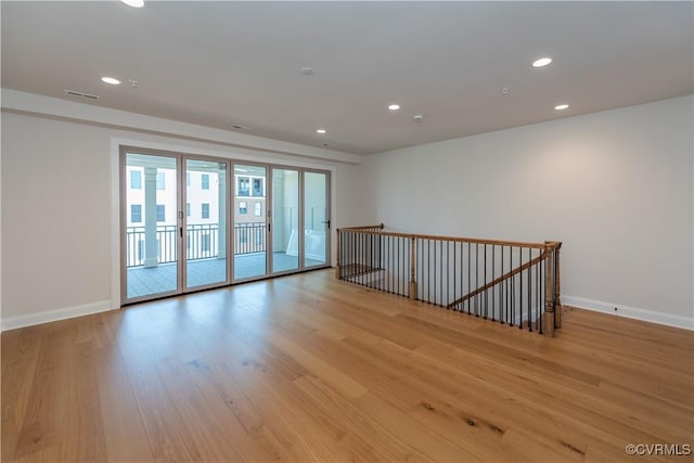 spare room with light hardwood / wood-style floors