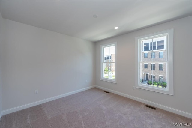 empty room featuring light colored carpet