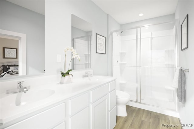 bathroom with walk in shower, toilet, and hardwood / wood-style flooring