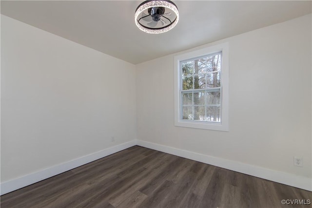 empty room featuring dark hardwood / wood-style flooring and ceiling fan