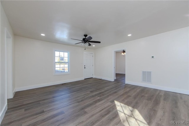 unfurnished room with dark hardwood / wood-style flooring and ceiling fan