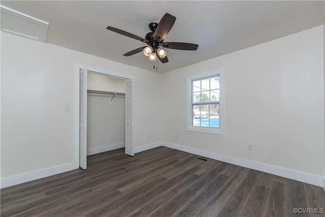 unfurnished bedroom with ceiling fan, dark hardwood / wood-style flooring, and a closet