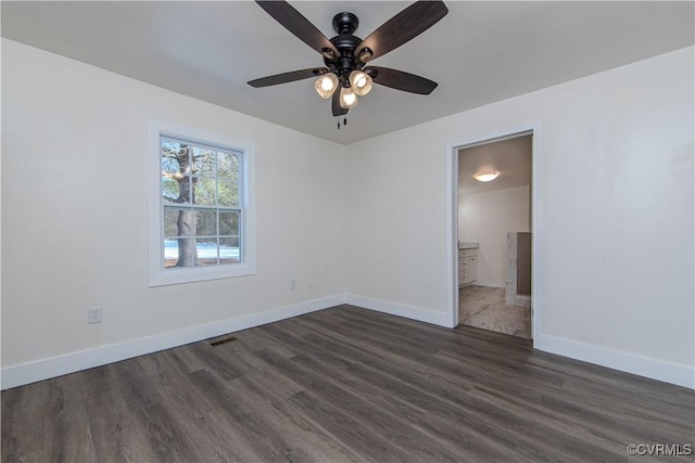 unfurnished room with ceiling fan and dark wood-type flooring