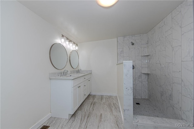 bathroom with vanity and tiled shower