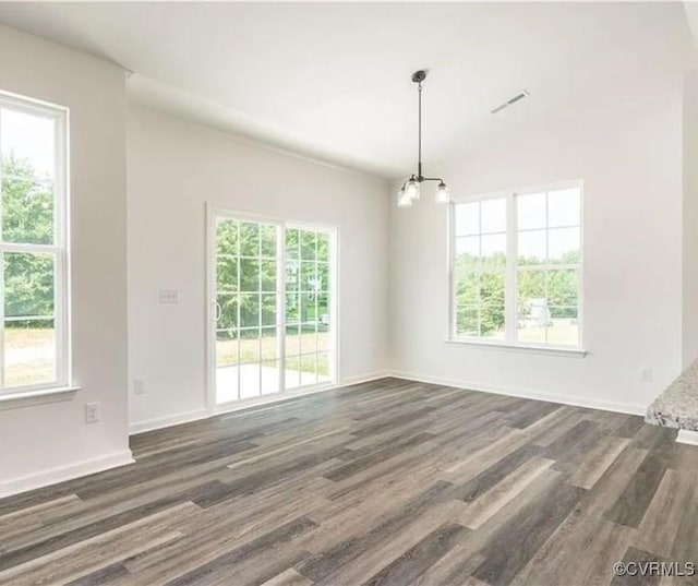 unfurnished room with dark hardwood / wood-style flooring and a notable chandelier