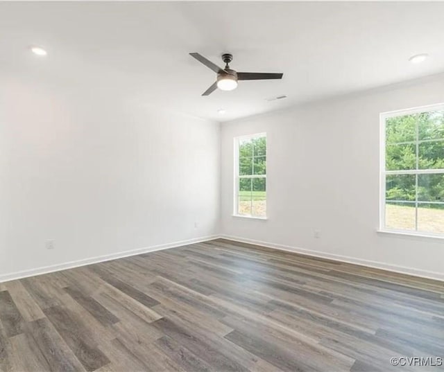 spare room with ceiling fan and dark wood-type flooring