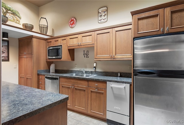 16460 W Crescent Ln, Hanover, VA 23192 - kitchen with stainless steel appliances, dark countertops, a sink, light tile patterned floors, and brown cabinets