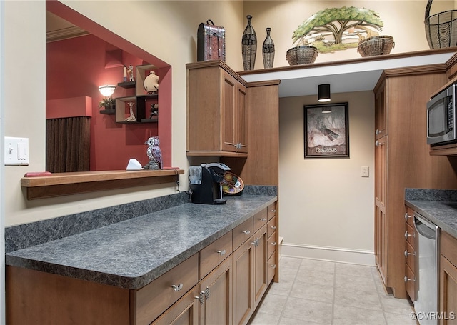 16460 W Crescent Ln, Hanover, VA 23192 - kitchen featuring appliances with stainless steel finishes, dark countertops, baseboards, and brown cabinets