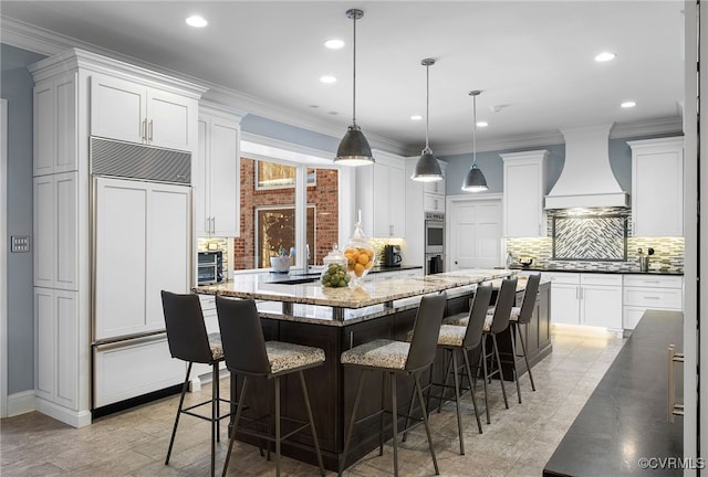 16460 W Crescent Ln, Hanover, VA 23192 - kitchen with paneled built in refrigerator, custom exhaust hood, stainless steel double oven, a spacious island, and decorative backsplash