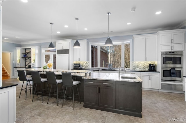 16460 W Crescent Ln, Hanover, VA 23192 - kitchen with double oven, a sink, decorative backsplash, white cabinets, and ornamental molding