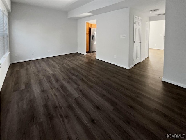 empty room with dark wood-type flooring