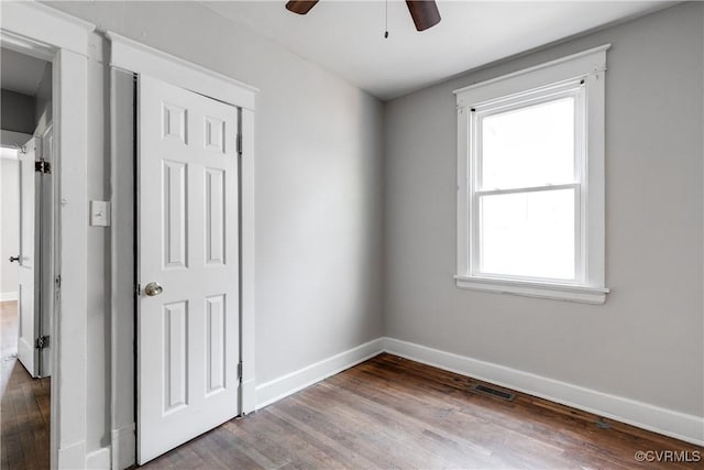 empty room featuring hardwood / wood-style floors, ceiling fan, and a healthy amount of sunlight