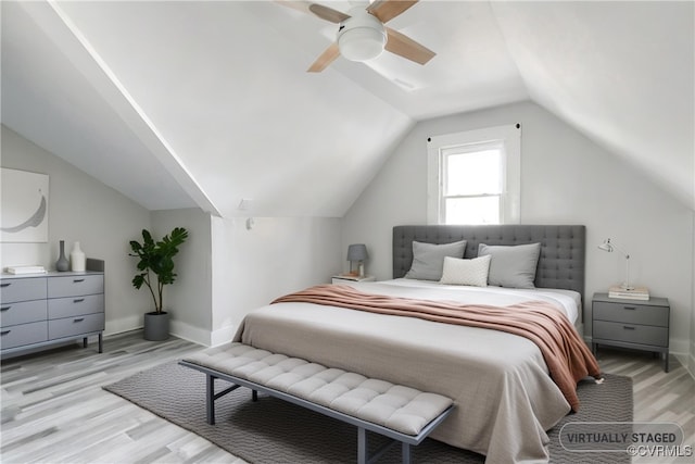 bedroom featuring ceiling fan, lofted ceiling, and light hardwood / wood-style flooring