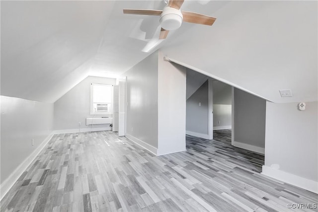 additional living space featuring ceiling fan, light wood-type flooring, and lofted ceiling