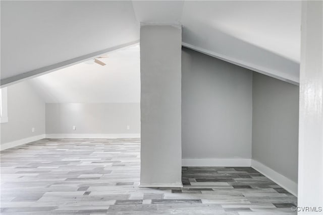 bonus room with light hardwood / wood-style flooring and vaulted ceiling