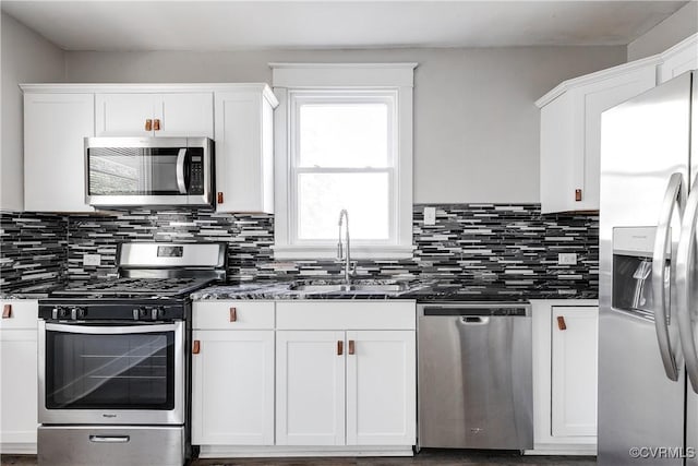 kitchen featuring stainless steel appliances, white cabinetry, and sink