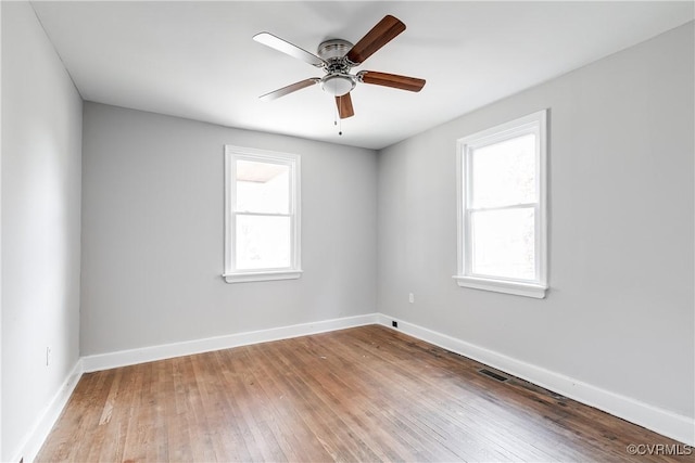 spare room featuring ceiling fan and light hardwood / wood-style flooring