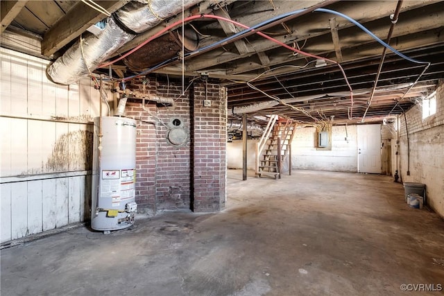 basement featuring gas water heater and electric panel