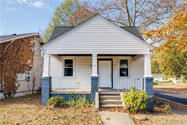 bungalow-style house featuring cooling unit and a porch